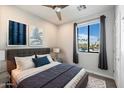 Tranquil bedroom with an outdoor view, decorative prints, and a plush rug at 6990 E 6Th St # 1016, Scottsdale, AZ 85251