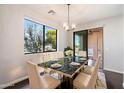 Bright dining room with a marble table, seating for six, and a view of the outdoors at 6990 E 6Th St # 1016, Scottsdale, AZ 85251