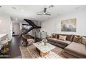 A cozy living room with a plush couch, modern staircase, and stylish decor at 6990 E 6Th St # 1016, Scottsdale, AZ 85251