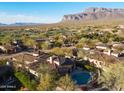 Aerial view of a beautiful home featuring a backyard pool, spa, lush landscaping, and mature trees at 8057 E Greythorn Dr, Gold Canyon, AZ 85118