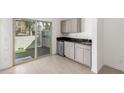 Open living space featuring built-in cabinets, stainless steel refrigerator, and sliding glass doors at 8255 N 22Nd Dr, Phoenix, AZ 85021