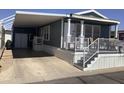 Exterior view of the home showing a covered parking area and front entrance at 8700 E University Dr # 1610, Mesa, AZ 85207