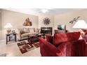 Comfortable living room featuring a fireplace, ceiling fan, and neutral color palette at 95 N Cooper Rd # 68, Chandler, AZ 85225