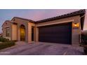 Well-maintained single-story home with neutral colors, desert landscaping, and an attached two-car garage at 10309 E Supernova Dr, Mesa, AZ 85212