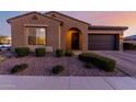 Charming single-story home featuring a desert landscape, arched entry, and a two-car garage at 10309 E Supernova Dr, Mesa, AZ 85212