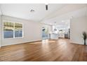 Bright living room featuring sleek hard surface floors, neutral paint, and an open concept design at 10619 W Sells Dr, Phoenix, AZ 85037