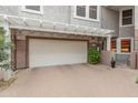 Spacious two car garage with brick paved drive, covered by a white pergola in a gated community at 15221 N Clubgate Dr # 1138, Scottsdale, AZ 85254