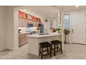 Bright kitchen with stainless steel appliances, breakfast bar with seating, and neutral countertops at 15221 N Clubgate Dr # 1138, Scottsdale, AZ 85254