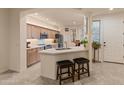 An open kitchen with modern appliances, a breakfast bar, and neutral-toned cabinetry at 15221 N Clubgate Dr # 1138, Scottsdale, AZ 85254