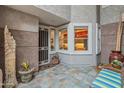 Inviting private patio with tiled floor, security screen door, and large window at 15221 N Clubgate Dr # 1138, Scottsdale, AZ 85254