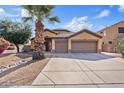 The exterior of this home has a two-car garage and well-maintained landscaping at 1619 E Beretta Pl, Chandler, AZ 85286
