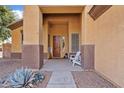 This is a front porch with nice decor and a white chair at 1619 E Beretta Pl, Chandler, AZ 85286