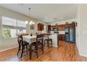 Inviting dining room with dark wood table, chandelier lighting, and easy access to kitchen at 1635 W Owens Way, Anthem, AZ 85086