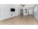 Spacious living room with tile flooring, neutral paint, ceiling fan and an open floorplan at 16848 W Bradford Way, Surprise, AZ 85374