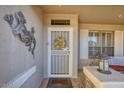 Welcoming front entrance with decorative wreath, security door, and sidelight windows at 17675 N Coconino Dr, Surprise, AZ 85374