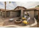 Charming home with a cozy fire pit area featuring comfortable seating and a brick patio, ideal for relaxation at 2501 E Milky Way, Gilbert, AZ 85295