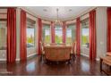 Elegant dining room featuring a chandelier and views of the backyard at 37267 Ne Greythorn Cir, Carefree, AZ 85377