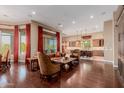 Open concept living room and kitchen with hardwood floors and large windows at 37267 Ne Greythorn Cir, Carefree, AZ 85377
