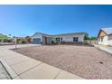 Well-kept single-story home with gravel landscaping, stone accents, and an attached garage on a sunny day at 3728 E Grove Ave, Mesa, AZ 85206