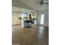 Bright kitchen with white cabinets, stainless steel appliances, kitchen island, and wood floor at 3728 E Grove Ave, Mesa, AZ 85206