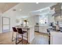 Bright kitchen with stainless steel appliances, center island, and wood-look floors, perfect for modern living at 3728 E Grove Ave, Mesa, AZ 85206