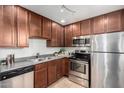 Functional kitchen with stainless steel appliances, dark cabinetry, and tiled floor offers practical cooking and cleaning at 4354 N 82Nd St # 183, Scottsdale, AZ 85251