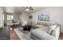 Comfortable living room flows into dining area, featuring gray sectional sofa and neutral tones for a serene ambiance at 4354 N 82Nd St # 183, Scottsdale, AZ 85251