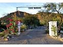 Scenic entrance to Casa Manana with desert landscape, flowers, and mountain views at 5710 E Camelback Rd, Phoenix, AZ 85018