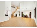 Bright living room featuring high ceilings, wood floors, and an elegant staircase at 6206 W Buckhorn Trl, Phoenix, AZ 85083