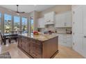 Kitchen with large wood island, white cabinets, and outdoor views at 6938 E Lomas Verdes Dr, Scottsdale, AZ 85266