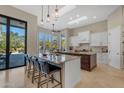 Bright kitchen featuring twin islands, breakfast bar, backyard and pool views at 6938 E Lomas Verdes Dr, Scottsdale, AZ 85266