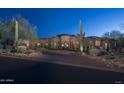 Beautiful estate home showcasing circular design, desert landscaping, and grand entrance at 9161 E Superstition Mountain Dr, Gold Canyon, AZ 85118