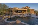 An expansive backyard features a pool with a waterfall and spa, plus plenty of room for lounging and entertaining at 9161 E Superstition Mountain Dr, Gold Canyon, AZ 85118