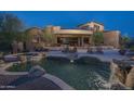 Inviting backyard pool with rock waterfall features and lounge area perfect for outdoor relaxation at 9161 E Superstition Mountain Dr, Gold Canyon, AZ 85118