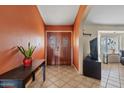 Welcoming foyer features a double-door entry, tile flooring, and warm, inviting colors at 10718 E Fenimore Rd, Mesa, AZ 85207