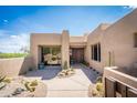 Desert home front entrance featuring large planters and a decorative wall at 11199 E Prospect Point Dr, Scottsdale, AZ 85262