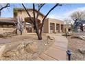 Stunning community clubhouse entrance featuring stone landscaping and paved walkway at 11500 E Cochise Dr # 2067, Scottsdale, AZ 85259