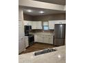 Bright kitchen features white cabinets, stainless appliances, and a modern design at 11500 E Cochise Dr # 2067, Scottsdale, AZ 85259