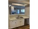 Modern kitchen featuring stainless steel appliances and white cabinets, offering a view to the living room at 11500 E Cochise Dr # 2067, Scottsdale, AZ 85259