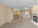 Cozy living room with a fireplace, open to the kitchen area for easy entertaining at 11500 E Cochise Dr # 2067, Scottsdale, AZ 85259