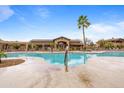 Gorgeous community pool with palm trees and luxurious lounge area, perfect for soaking up the sun at 11500 E Cochise Dr # 2067, Scottsdale, AZ 85259