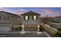 Attached two-car garage with brown garage door, and additional parking space in the driveway at 12343 W Essig Way, Peoria, AZ 85383