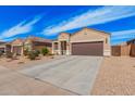 Charming single-story home featuring a two-car garage, neutral stucco, and low maintenance desert landscaping at 1250 E Eric Pl, Casa Grande, AZ 85122