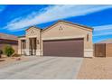 Charming single-story home featuring a two-car garage, neutral stucco, and low maintenance desert landscaping at 1250 E Eric Pl, Casa Grande, AZ 85122