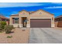 Charming single-story home featuring a two-car garage, neutral stucco, and low maintenance desert landscaping at 1250 E Eric Pl, Casa Grande, AZ 85122