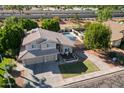 Aerial view of a tan two-story home featuring a pool and manicured lawn at 1320 N Desoto St, Chandler, AZ 85224