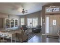 The living room has a ceiling fan and an exterior door with decorative windows and a white storage cabinet at 1320 N Desoto St, Chandler, AZ 85224