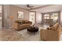 Cozy living room featuring neutral tones, comfortable seating, and an adjacent dining area at 18060 W Rimrock St, Surprise, AZ 85388