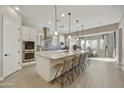 Bright, modern kitchen with large island, stainless appliances, tile floors and blue backsplash at 19235 E Peartree Ln, Queen Creek, AZ 85142