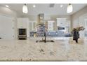 Modern kitchen with white cabinets, granite countertops, a stainless hood, and a decorative tile backsplash at 19235 E Peartree Ln, Queen Creek, AZ 85142
